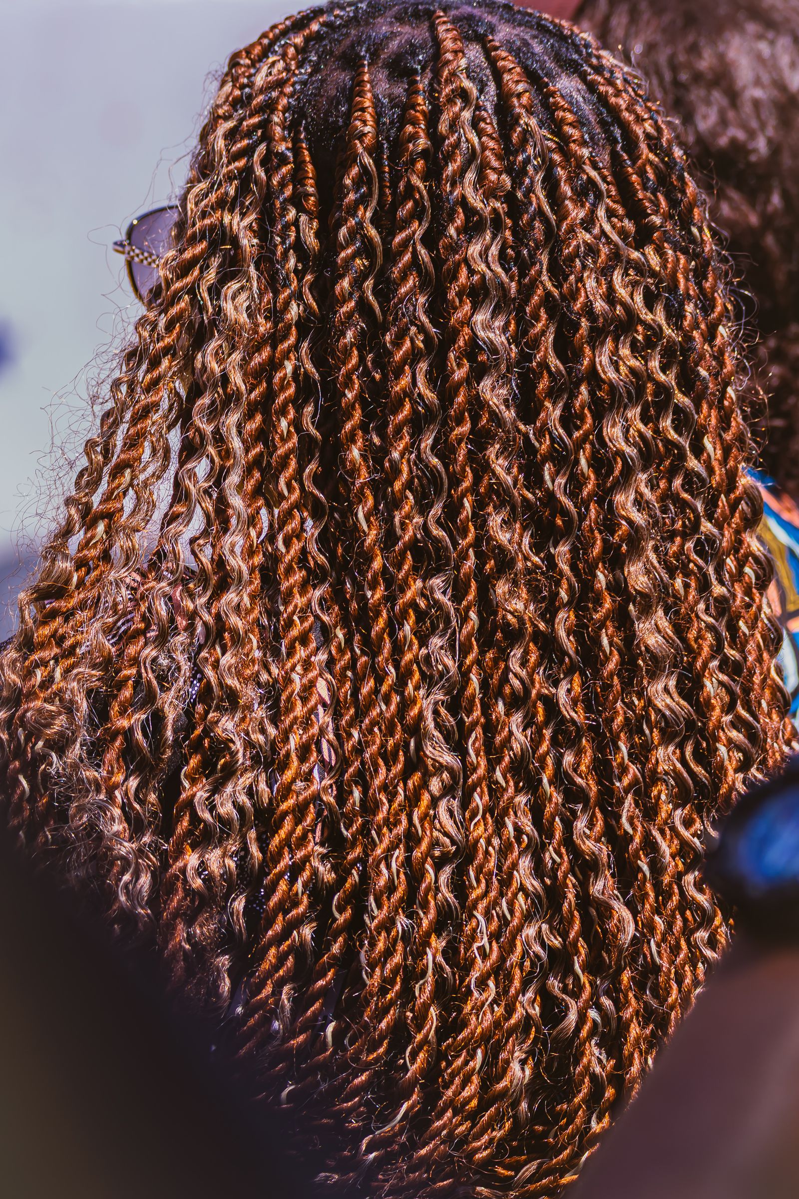 Stylist working on a Black woman's weave